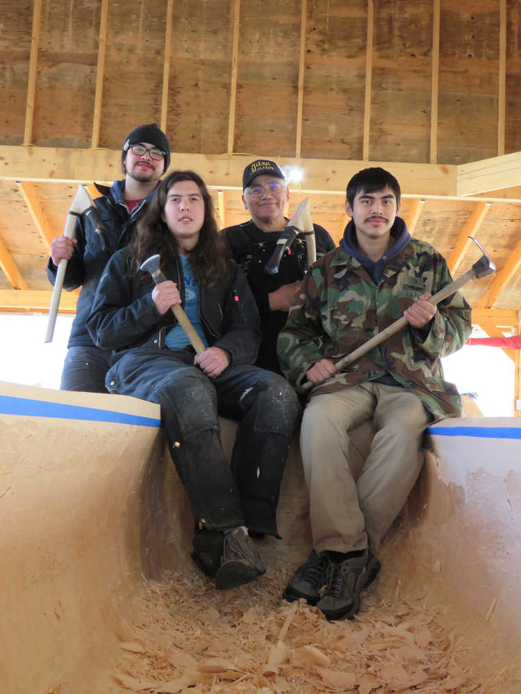 From left, carvers James (Gooch Éesh) Hart, Zack (Tlél Tooch Tláa.aa) James, Wayne Price, and Steven Price are carving two 40-foot canoes out of spruce for the Huna Tlingit to paddle into Glacier Bay for their ceremonial return, and the dedication of the Xúna Shuká Hit tribal house, on August 25 of this year. Photos by Mary Catharine Martin | Capital City Weekly