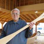 Hoonah elder Melvin Williams, 74, whose father was carver David Williams Sr., has visited the carvers working on the canoes every day, bringing them food, telling them stories, and working on paddles for those who might not have a paddle of their own. This in-progress paddle is his fourth.