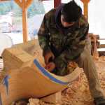 Steven Price, son of master carver Wayne Price, works on a dugout canoe to be displayed by the National Park Service in Skagway.