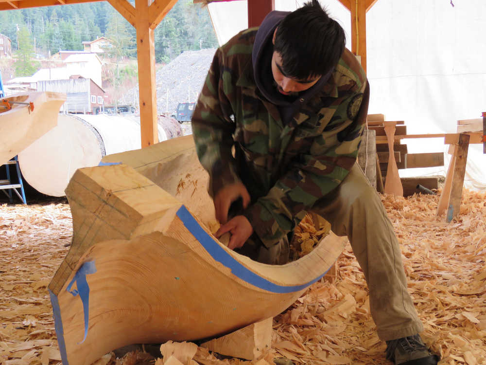 Steven Price, son of master carver Wayne Price, works on a dugout canoe to be displayed by the National Park Service in Skagway.