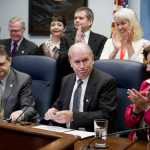 Gov. Bill Walker reacts to the applause of legislators after signing Senate Bill 23 at the Capitol on Monday. The bill gives public access to the life-saving heroin antidote called Naxolone. Sen. Johnny Ellis, D-Anchorage, sitting left, and Rep. Lynn Gattis, R-Wasilla, sitting right, sponsored the bill in the Senate and House.