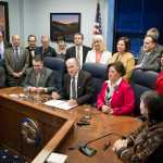 Legislators line up behind Gov. Bill Walker signs Senate Bill 23 at the Capitol on Monday. The bill gives public access to the life-saving heroin antidote called Naxolone. Sen. Johnny Ellis, D-Anchorage, sitting left, and Rep. Lynn Gattis, R-Wasilla, sitting right, sponsored the bill in the Senate and House.