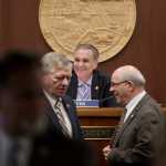 Senate President Kevin Meyer, R-Anchorage, shares a light moment with other senators during debate of the state's operating budget at the Capitol on Monday.