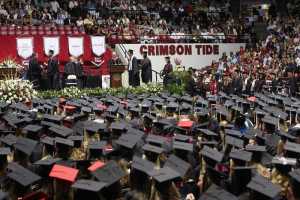 In this Aug. 6, 2011 photo, University of Alabama students receive their diplomas at Coleman Coliseum in Tuscaloosa, Alabama. While 58 percent of black male undergraduates at the 65 schools in the Power 5 conferences got degrees within six years, 54 percent of black male student-athletes at the same schools graduated, according to an analysis of the 2014-2015 academic year by University of Pennsylvania researcher Shaun Harper.