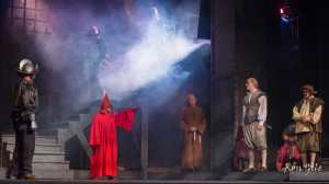 Don Quixote (Myron Welling) faces the Inquisitor (Kim Andree) as the Padre (Jay Query) and sidekick Sancho (Odin Brudie) look on.