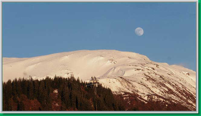 Moon and sun over Mt. Roberts.
