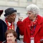 Former Rosies, Clara Doutly, left, and Pat Duncan, strike the Rosie the Riverter pose on the Capitol grounds on Tuesday in Washington.