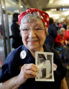 Former Rosie, T. Ogden of Aurora, Illinois, shows a photo of herself after greeting fellow Rosies from Michigan on their arrival in Washington on Tuesday.