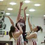 Haines' Jaime Stanford shoots between Hoonah's Mariah Martin, left, and Brooke Lampe during their Womens bracket game in the 2016 Juneau Lions Club 70th Gold Medal Basketball Tournament at Juneau-Douglas High School on Tuesday.