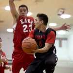 Hoonah's Richard Moore looks to pass against Kake's  Dean Cavanaugh during their B bracket game in the 2016 Juneau Lions Club 70th Gold Medal Basketball Tournament at Juneau-Douglas High School on Tuesday.