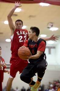 Hoonah's Richard Moore looks to pass against Kake's  Dean Cavanaugh during their B bracket game in the 2016 Juneau Lions Club 70th Gold Medal Basketball Tournament at Juneau-Douglas High School on Tuesday.