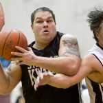 Klukwan's Tim Wilson, left, grabs a loose ball in front of Yakutat's Gary Klushkan during their Masters bracket game in the 2016 Juneau Lions Club 70th Gold Medal Basketball Tournament at Juneau-Douglas High School on Wednesday.