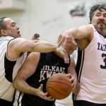 Klukwan's Steve Brandner, center, is sandwiched between Yakutat's Bob Rockwood, left, and Gary Klushkan during their Masters bracket game in the 2016 Juneau Lions Club 70th Gold Medal Basketball Tournament at Juneau-Douglas High School on Wednesday.