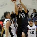 Klukwan's Dan Hotch drives to the basket between Yakutat's Gary Klushkan, left, and Sam Demmert during their Masters bracket game in the 2016 Juneau Lions Club 70th Gold Medal Basketball Tournament at Juneau-Douglas High School on Wednesday.