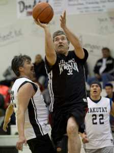 Klukwan's Dan Hotch drives to the basket between Yakutat's Gary Klushkan, left, and Sam Demmert during their Masters bracket game in the 2016 Juneau Lions Club 70th Gold Medal Basketball Tournament at Juneau-Douglas High School on Wednesday.