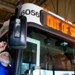 Driver Dale Mazzei cleans mirrors on a bus before starting his route from the city's Capitol Transit bus barn on Thursday.