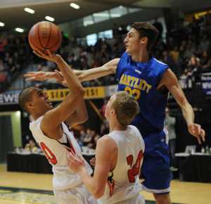 Juneau's Molo Maka puts up a shot against the defense of Bartlett's Kaejae Mader while Crimson Bear teammate Guy Bean looks on.