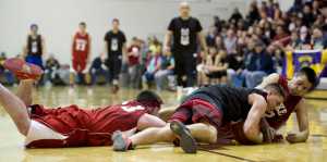 Hydaburg's Vinny Edenshas, center, wrestles a loose ball away from Kake's Lance Doake, right, and Shea Jackson during their B bracket game in the 2016 Juneau Lions Club 70th Gold Medal Basketball Tournament at Juneau-Douglas High School on Thursday. Hydaburg won 76-72.