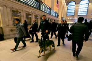 In this March 22 photo, Metro-North Railroad police officers with a police dog patrol Grand Central Terminal, in New York.