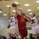 Kake's Rob Jackson rebounds against Huna's Ed Mercer Jr., left, and Pete Schneeberger, right, during their 70th annual Gold Medal Basketball Tournament championship game Saturday  at Juneau-Douglas High School. Kake won 70-64.