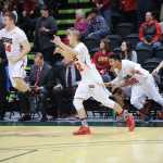 From left, Juneau-Douglas High School's Hunter Hickok, Jordan Milligan and Sebastian Bradley react to the final buzzer after defeating Dimond High School to claim the ASAA March Madness Alaska 4A title on Saturday in Anchorage.
