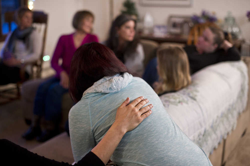 Director Kara Nelson, left, offers her support to resident Daricka Clark after a group dinner at Haven House on Tuesday. Haven House is celebrating its one-year anniversary as a transitional home for recently released female prisoners and women coming out of substance abuse or mental health treatment.