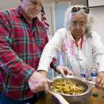 Helen Watkins is helped by her husband, Ray, as they prepare Devil's Club ointment for a class at Yaakoosge Daakahidi Alternative High School in April 2015.
