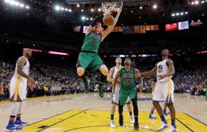 Boston Celtics' Jonas Jerebko (8) dunks against the Golden State Warriors during the second half of an NBA basketball game Friday in Oakland, California. Boston won 109-106.
