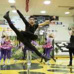 Jonah Gonzales, playing a witch, does a kick during the "Enchanted Forest" tournament routine.