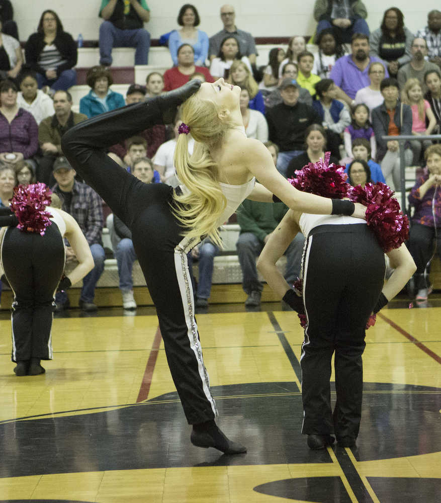 Ashley Wittwer, senior captain of the team, impresses with her flexibility in the pom routine.