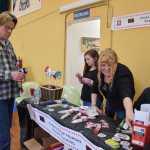 Ann Nielsen shows a Juneau resident the various tools available for free in the community to safely handle exposed syringes that more often now are showing up on hiking trails and near parking lots. Nielsen volunteers with the Juneau group "Stop Heroin, Start Talking," which took part in the "Hope, Not Heroin" event Saturday inside the Juneau Arts & Culture Center.