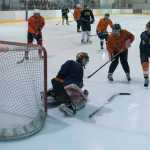 Jonas Lamb scores Michigan's second goal past Tigers goalie Devin Savikko. Michigan defeated the Tigers 5-1.