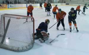 Jonas Lamb scores Michigan's second goal past Tigers goalie Devin Savikko. Michigan defeated the Tigers 5-1.