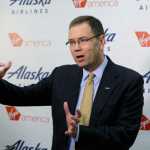 Brad Tilden, Alaska Airlines president and CEO, talks to reporters, Monday, April 4, 2016, at the airlines' corporate headquarters in Seattle. Alaska Airlines' parent company announced Monday that it will pay $2.6 billion to buy the Richard Branson-inspired, California-based Virgin America. (AP Photo/Ted S. Warren)