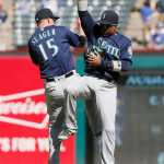 Seattle Mariners Kyle Seager (15) and Robinson Cano, right, celebrate a 9-5 win over the Texas Rangers after a baseball game, Wednesday, April 6, 2016, in Arlington, Texas. (AP Photo/Brandon Wade)