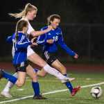 Juneau-Douglas's Maddie McKeown, center, shoots between Thunder Mountain's Kayla Duncan, left, and Sienna Hanna during their at Adair-Kennedy Memorial Park on Friday.