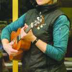 ADVANCE FOR WEEKEND APRIL 9-10, 2016 AND THEREAFTER -- In this Feb. 10, 2016 photo, ukulele instructor Kathy Paulson leads a ukulele lesson at the public library in Ketchikan, Alaska. When walking through the Ketchikan Public Library or down a hall of the University of Alaska Southeast Ketchikan Campusâ€™ Robertson Building or even through a quiet residential neighborhood one evening, there is a chance you could hear the dulcet tone of an instrument more often associated with the Hawaiian Islands, not an island in Southeast Alaska. However, a group of mostly local residents over the past year has gotten together to pluck out songs ranging from "Blowin' in the Wind" to "Bad Moon Rising" to "Hey Good Lookin'" and everything in between on the ukulele. They are the Southeast Strummers. (Taylor Balkom/Ketchikan Daily News via AP)