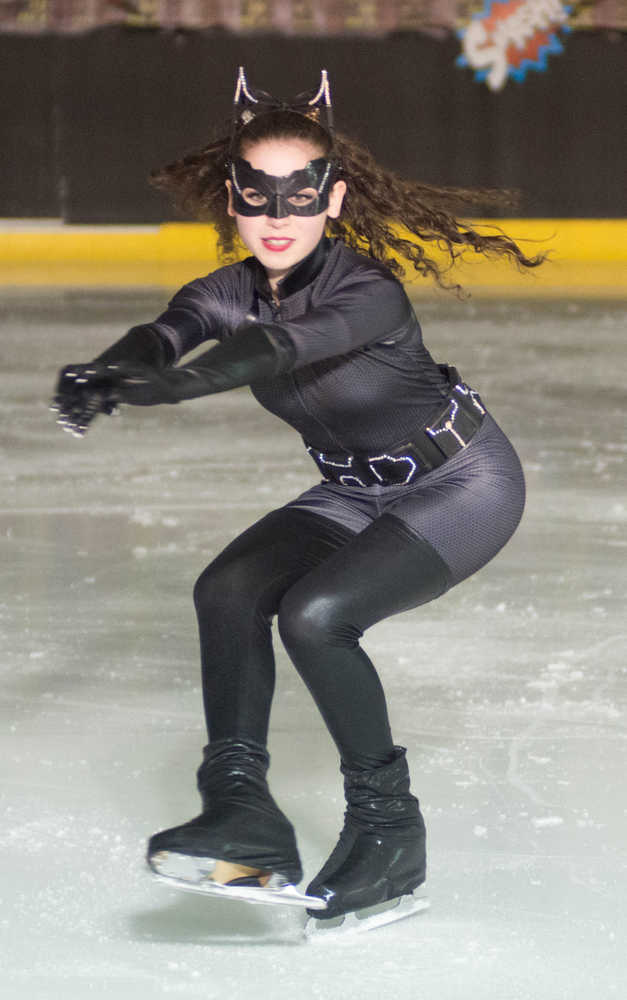 Olivia Gardner wears a Cat Woman costume while performing during the Juneau Skating Club's "Heroes and Villains" show at Treadwell Arena on Saturday.