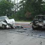 Deirdre's car is on the left, and her purse can be seen resting on the trunk area. To the right is the Dodge Neon which hit Deirdre and then caught on fire.