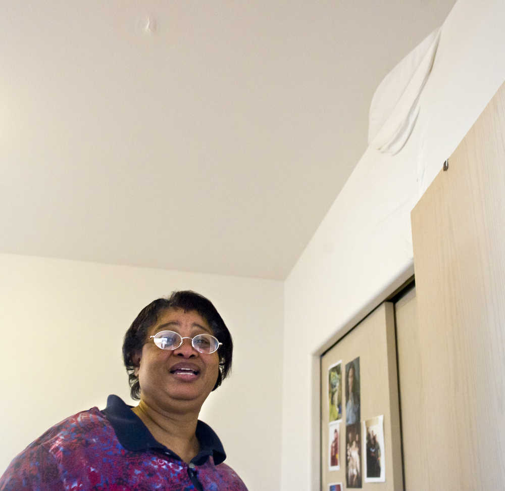 Cecil Welch shows water damage to her apartment on the second floor of the Channel View Apartments on Monday. A fire in a fifth floor apartment causes the evacuation of residents in the 22-apartment complex on Sunday.