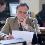 Sen. Peter Micciche, R-Soldotna, studies a chart during the introduction of a new Permanent Fund Dividend bill in the Senate Finance Committee Tuesday that aims to reduce Alaska's budget deficit.