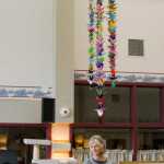 Harborview Elementary School fifth-graders Madeline Germain, left, and Tahlia Gerger talk about the history of paper cranes during a visit to the Juneau Pioneer Home on Thursday.