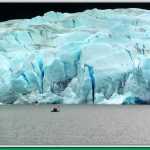 A lone kayaker is dwarfed by Mendenhall Glacier.