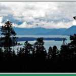 Spruce silhouettes with Mansfield Peninsula and the Chilkats in the background.