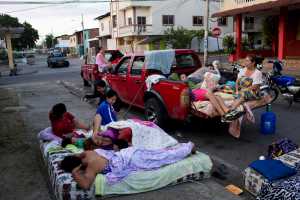 Families wake up after sleeping outside their collapsed homes that were destroyed by an earthquake in Manta, Ecuador, Tuesday, April 19, 2016. The strongest earthquake to hit Ecuador in decades flattened buildings and buckled highways along its Pacific coast, sending the Andean nation into a state of emergency. (AP Photo/Rodrigo Abd)