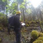 Michael Melendrez records stream data as part of forestry training. Photo by Quinn Aboudara.