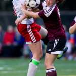 Juneau-Douglas' Rylee Landen, left, collides with Ketchikan's Tia Simpson during their varsity game at Adair-Kennedy Memorial Park on Friday.