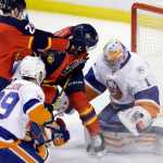 New York Islanders goalie Thomas Greiss (1) stops a shot as he defends against Florida Panthers left wing Garrett Wilson (28) and Logan Shaw (48) during the second period of Game 5 of an NHL hockey first-round Stanley Cup playoff series, Friday, April 22, 2016, in Sunrise, Fla. (AP Photo/Alan Diaz)