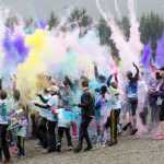 Runners celebrate their success by throwing many different colors up in the air during Sunday's Raining Colors 5K Fun Run. Proceeds benefit the Juneau Youth Triathlon Club.