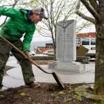 Dale McFarlin, of the city landscaping division, weeds the garden next to the Archie Van Winkle memorial on South Franklin Street on Tuesday.